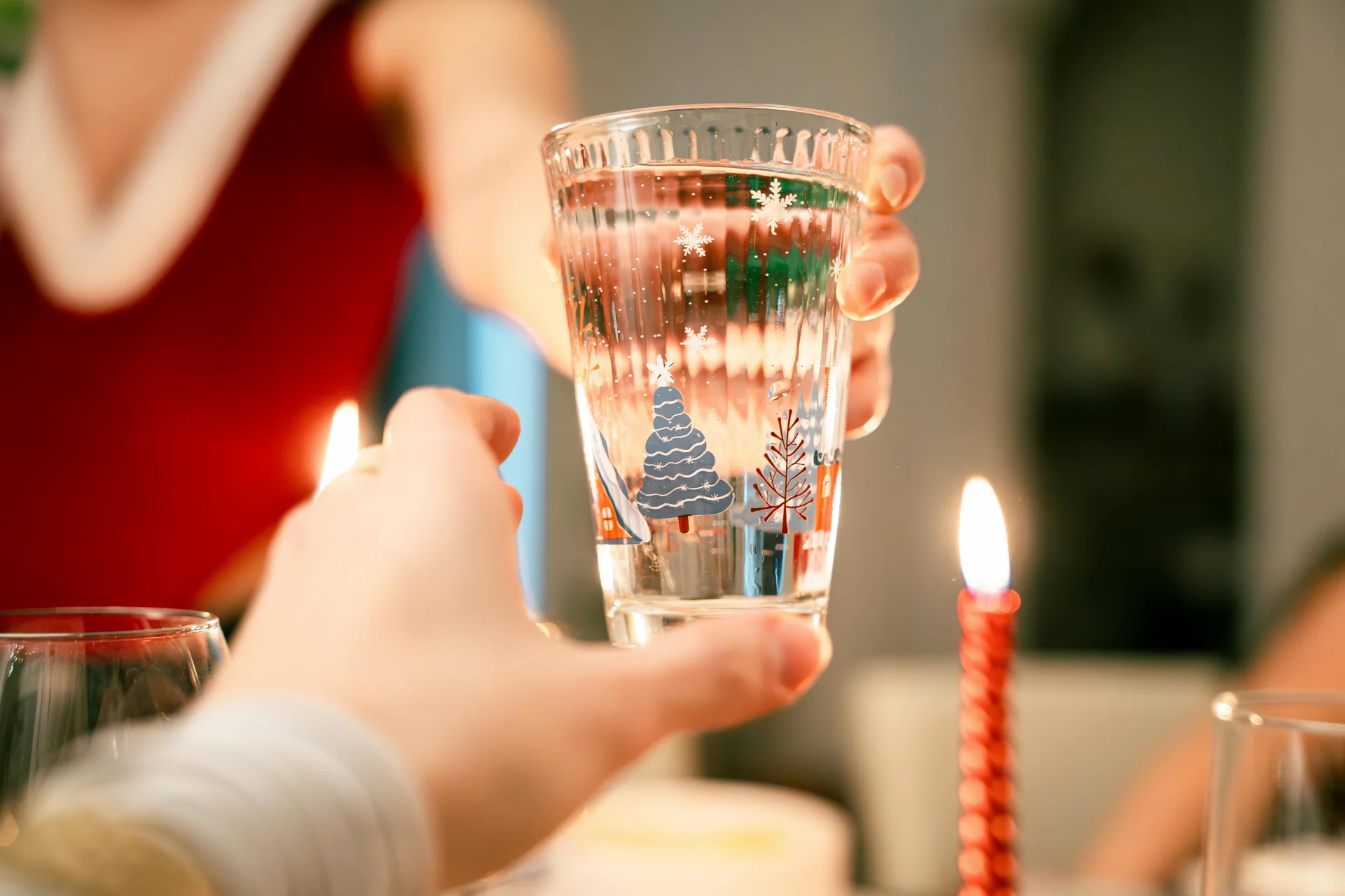 A glass of pure water with lemon on a festive table