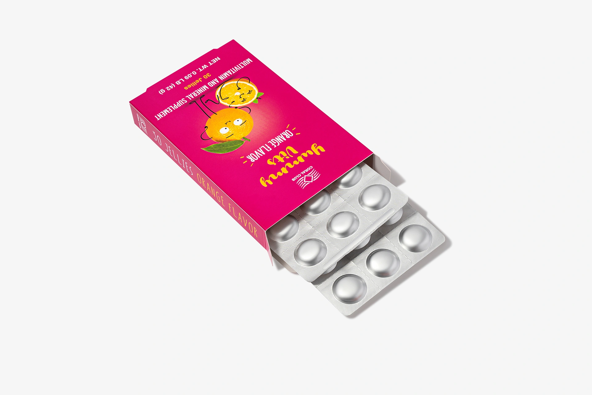Yummy Vits Orange chewable vitamins in a child's hands against a healthy morning breakfast background